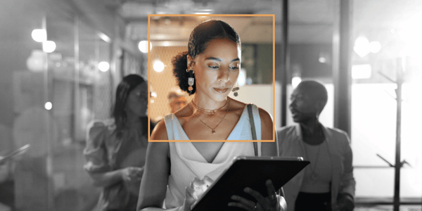 AI-driven workplace transformation: person using tablet in modern office, highlighted to represent focus and digital change
